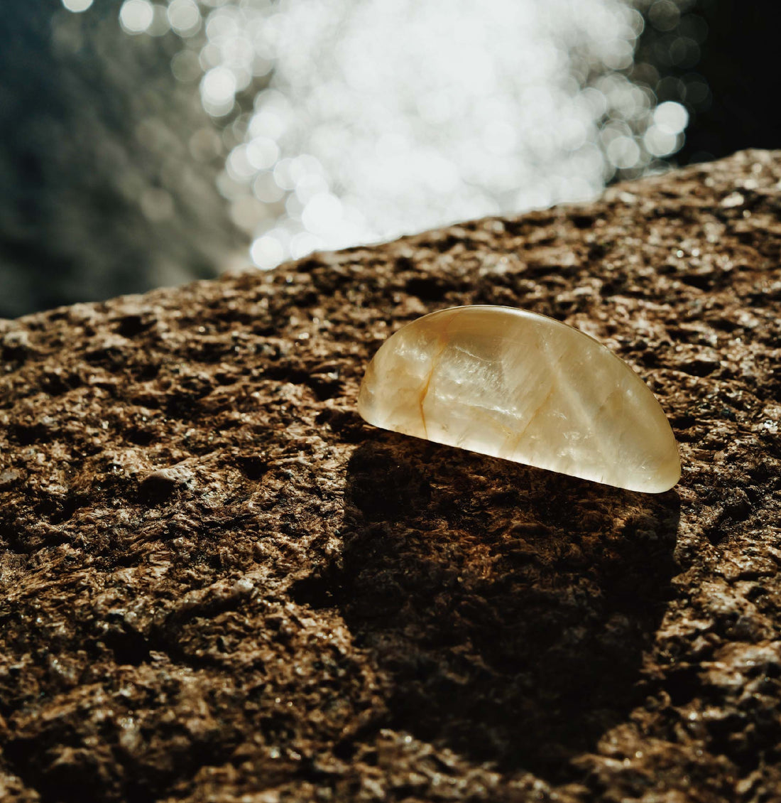 Citrine healing stone resting on natural texture for solar plexus chakra healing