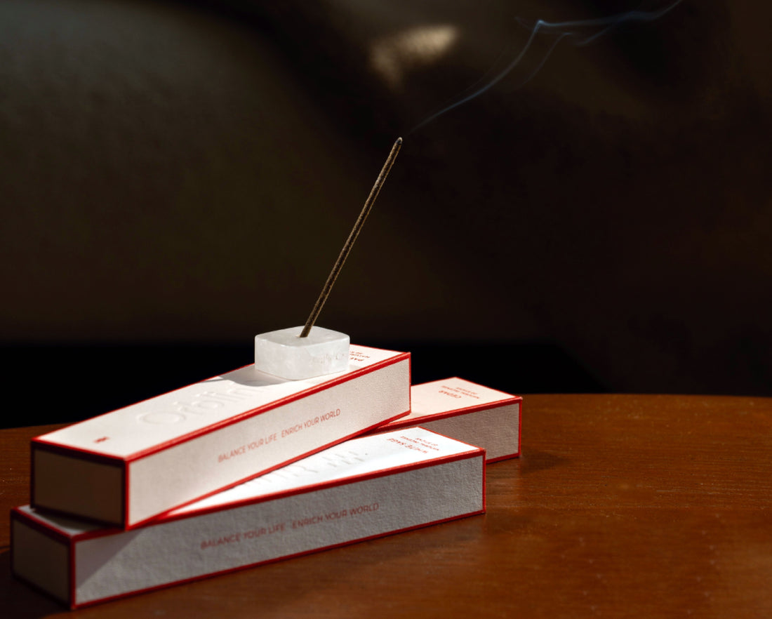 Lit incense stick burning in the included crystal holder from the Orblink Purification set, creating a meditative atmosphere