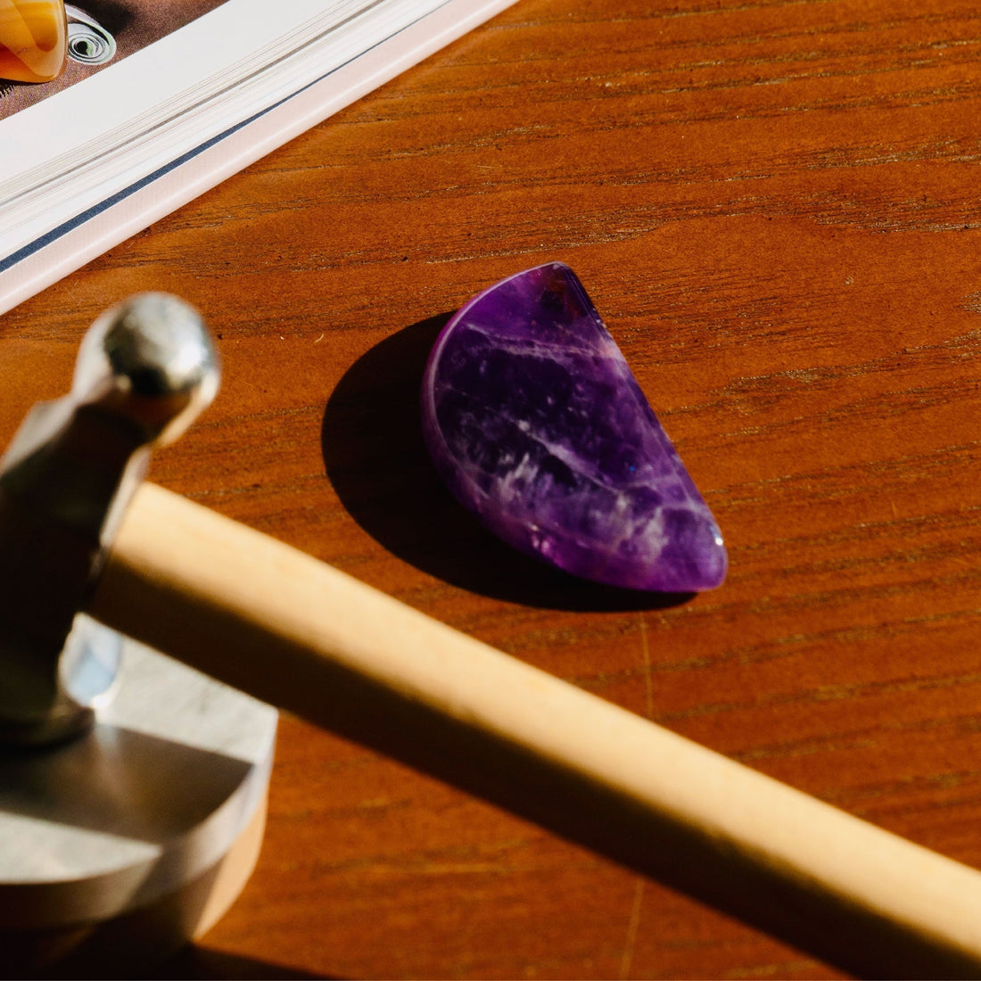 Amethyst healing stone placed on wooden desk for focus and deep work study