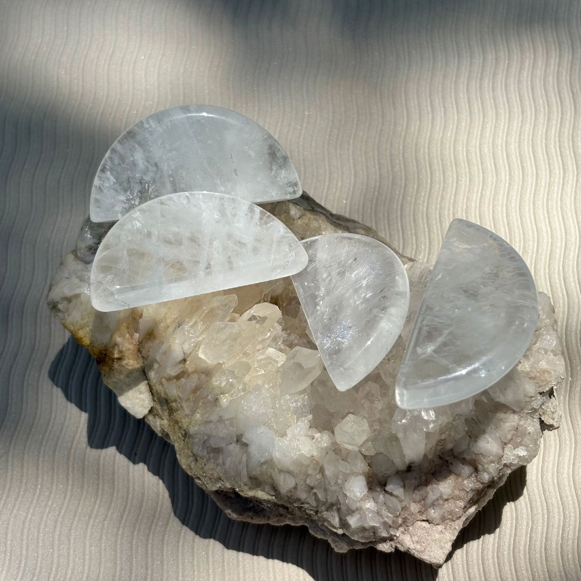 Orblink Clear Quartz Healing Stones - Polished Crystals Charging on Raw Cluster in Sunlight