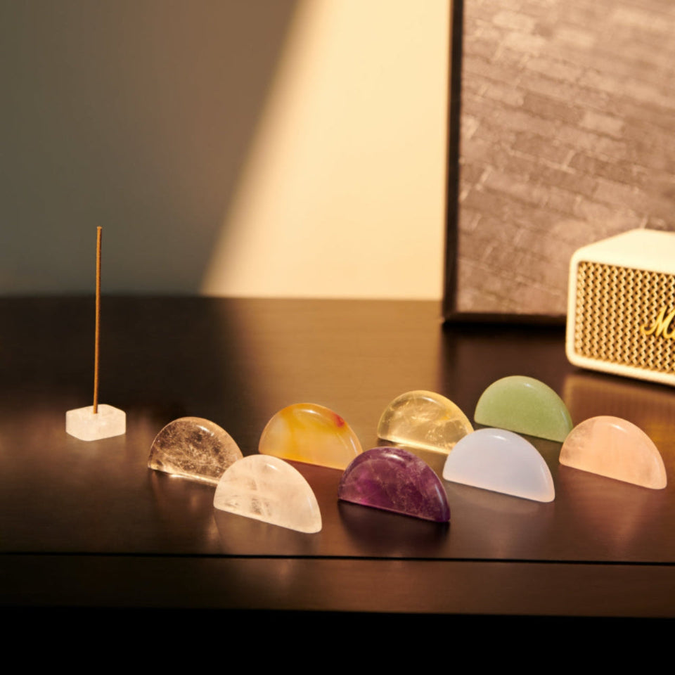Set of colorful crystal stones on a dark surface with a blurred background