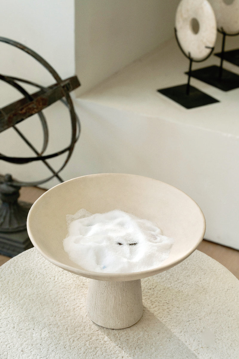 Ceramic pedestal bowl filled with coarse sea salt for deep earth crystal cleansing and energetic detox ritual