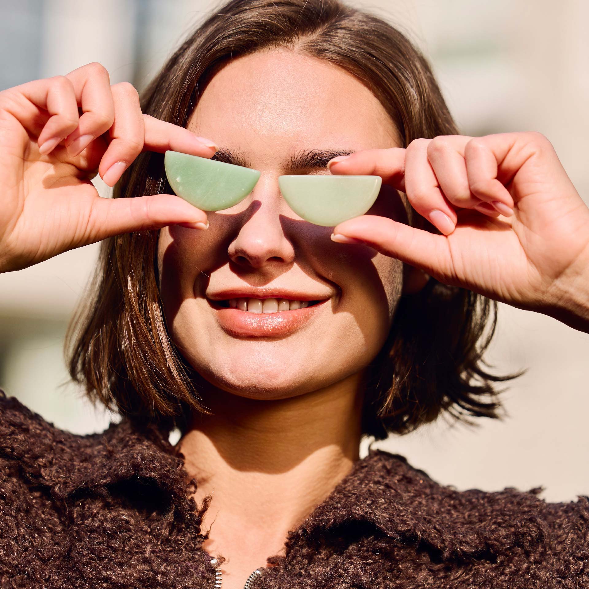 Orblink Green Aventurine Lifestyle - Woman Holding Stones Over Eyes Representing Optimism & New Opportunities