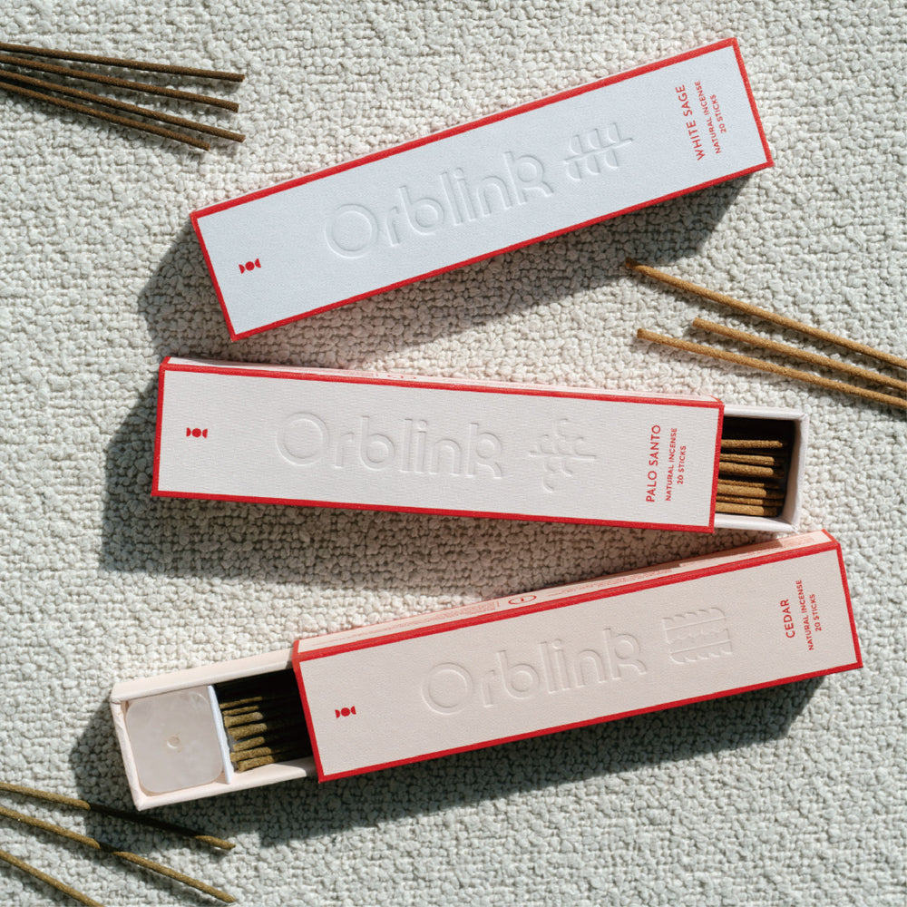 Orblink Sacred Woods Trilogy incense set featuring White Sage, Palo Santo, and Cedar. Open box revealing natural incense sticks and included crystal holder