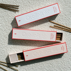 Orblink Sacred Woods Trilogy incense set featuring White Sage, Palo Santo, and Cedar. Open box revealing natural incense sticks and included crystal holder