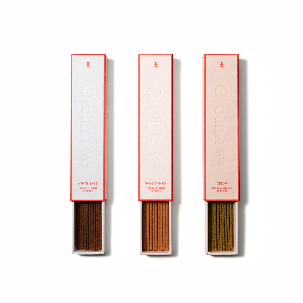 Orblink Sacred Woods Trilogy incense set featuring White Sage, Palo Santo, and Cedar. Open box revealing natural incense sticks and included crystal holder