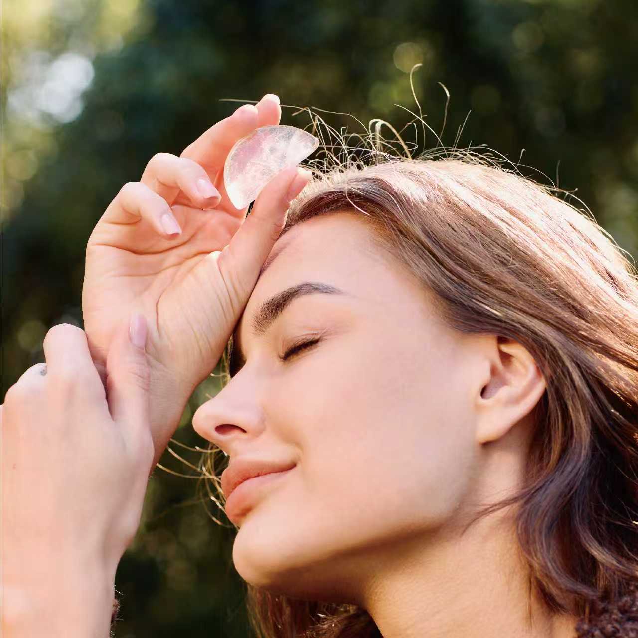 Orblink Clear Quartz Lifestyle - Woman Meditating with Stone on Forehead for Mental Clarity & Mindfulness
